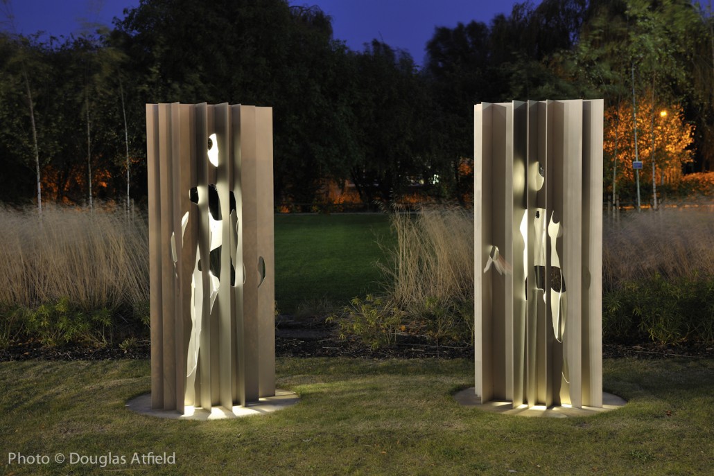 Two stainless steel figures in the grounds of ARU