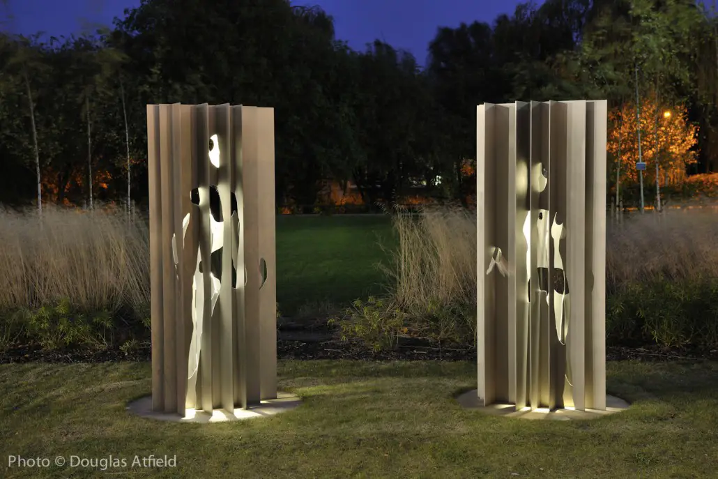 Two stainless steel figures in the grounds of ARU