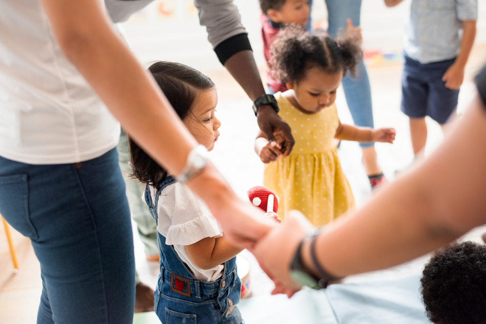 Toddlers enjoying a dance lesson with parents