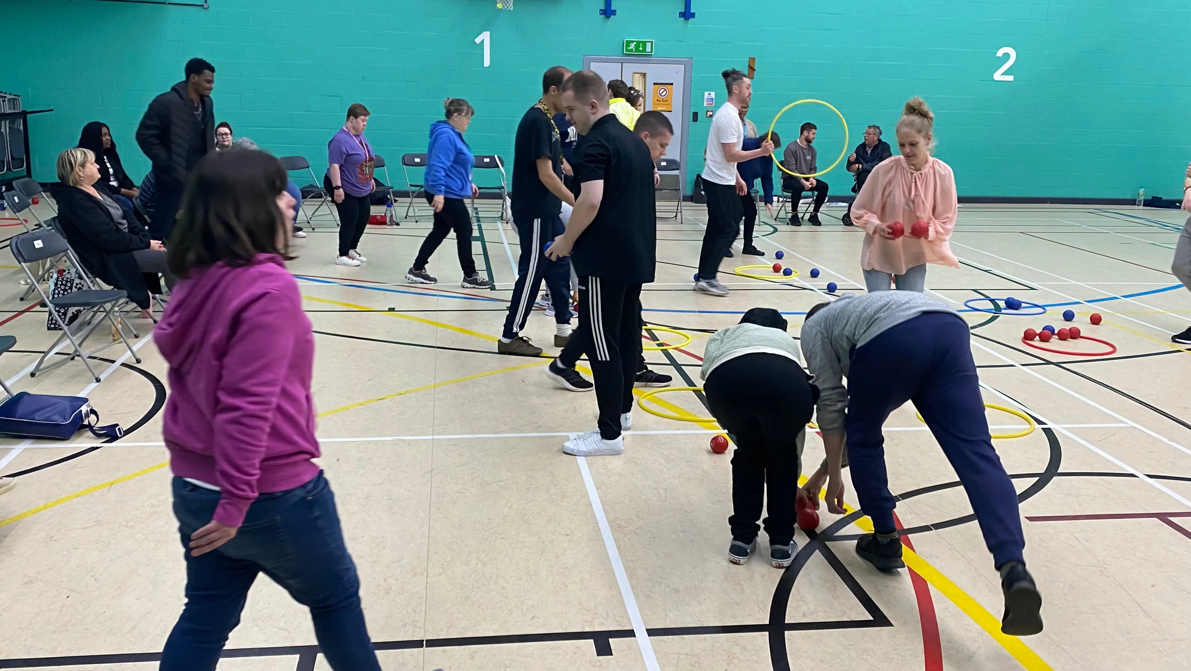 A group of people setting up and playing boccia