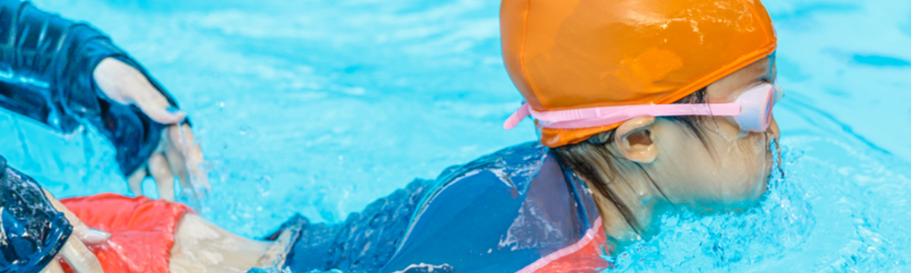 Young child learning to swim