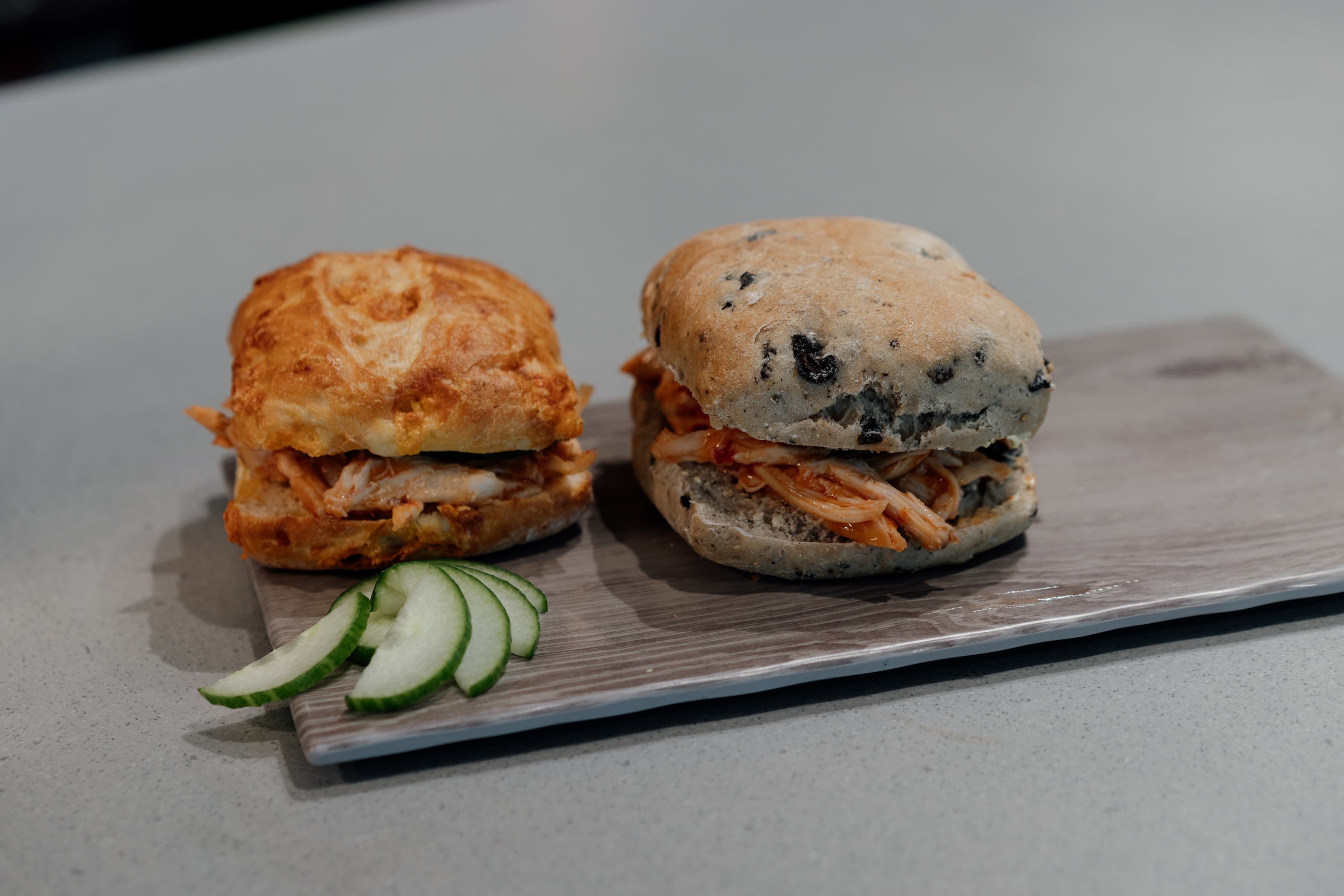 Two sandwiches with cucumber garnish preview