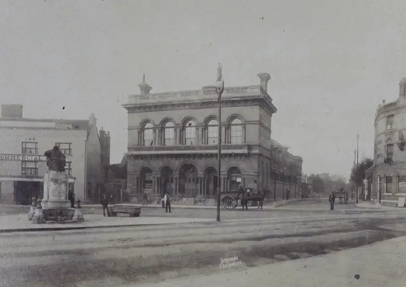 Large stone building, with statue of Judge Tidal in front (black and white photo)