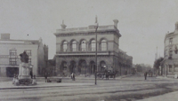 Large stone building, with statue of Judge Tidal in front (black and white photo) preview