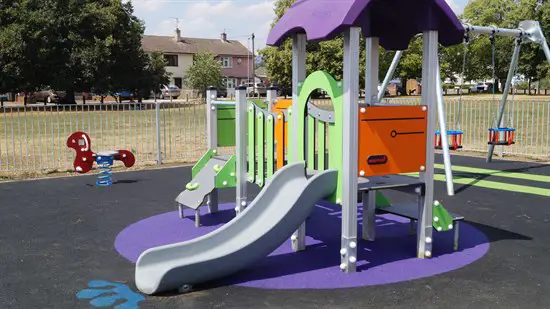 Play area with slide and swings