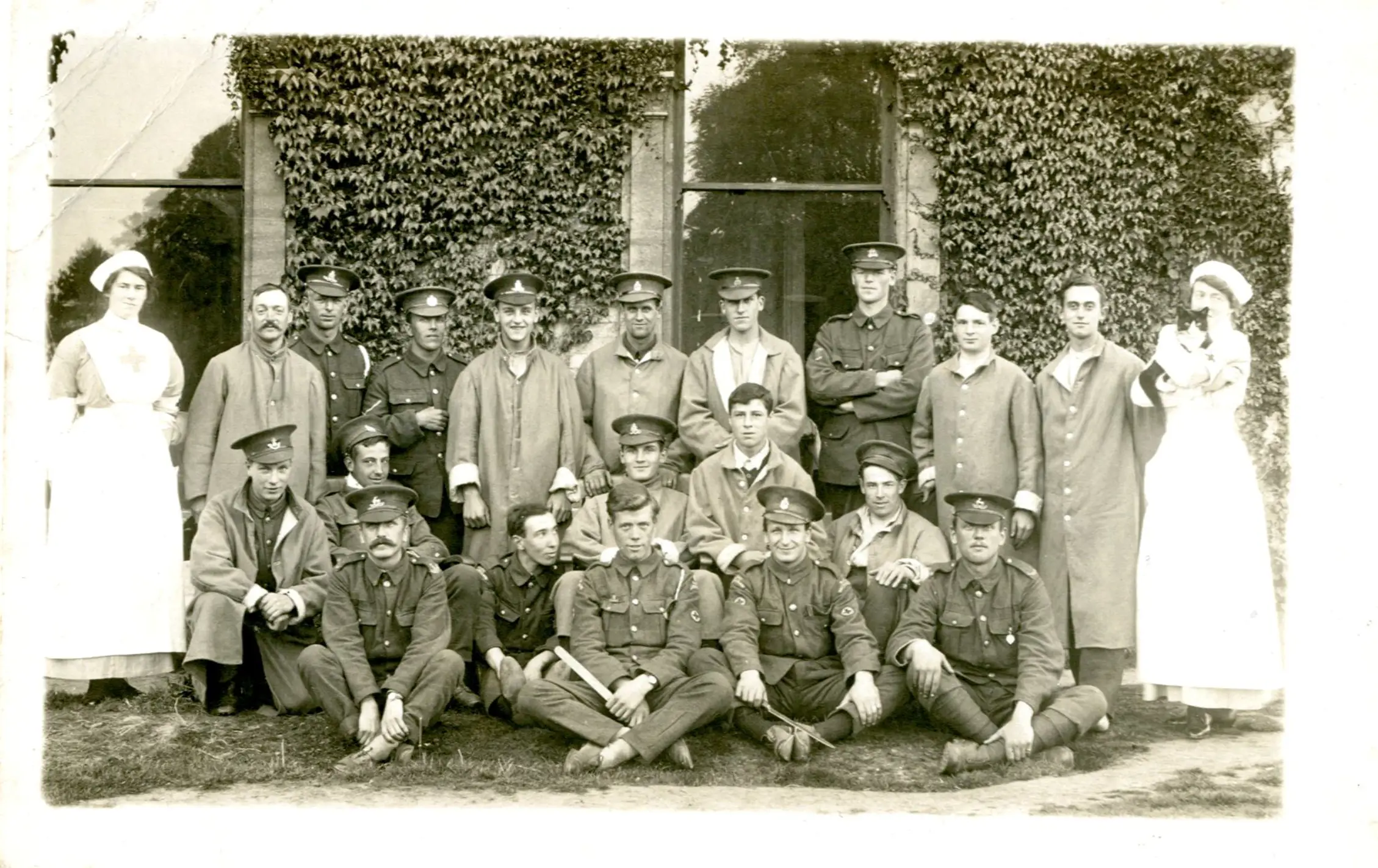 Outside Oaklands House with the patients and nurses. The nurse on the far right holding a black and white cat
