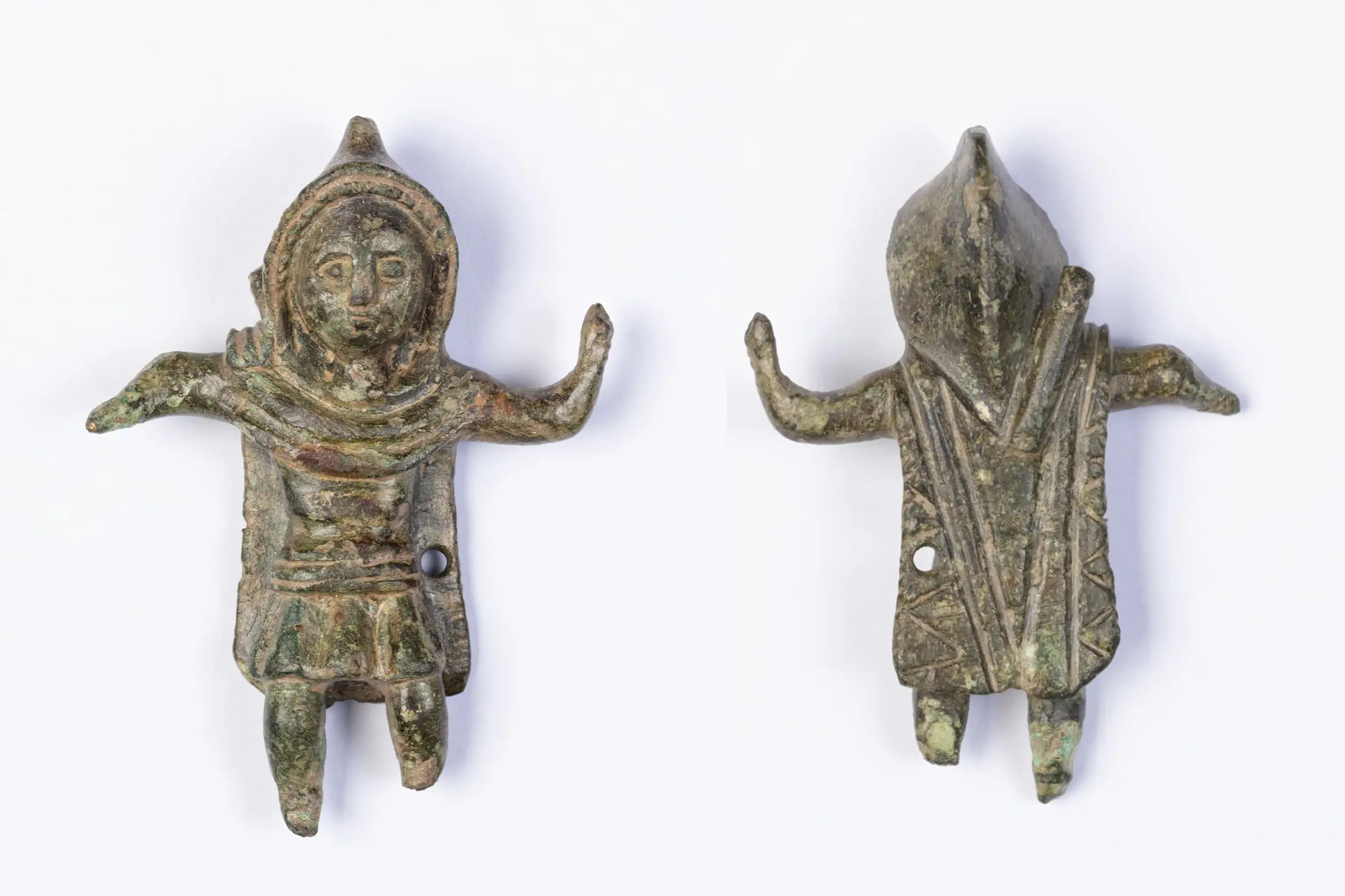 Front and back of a tiny statue wearing a hooded cloak. 