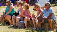 Fling attendees hanging out on hay bales preview