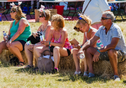 Fling attendees hanging out on hay bales