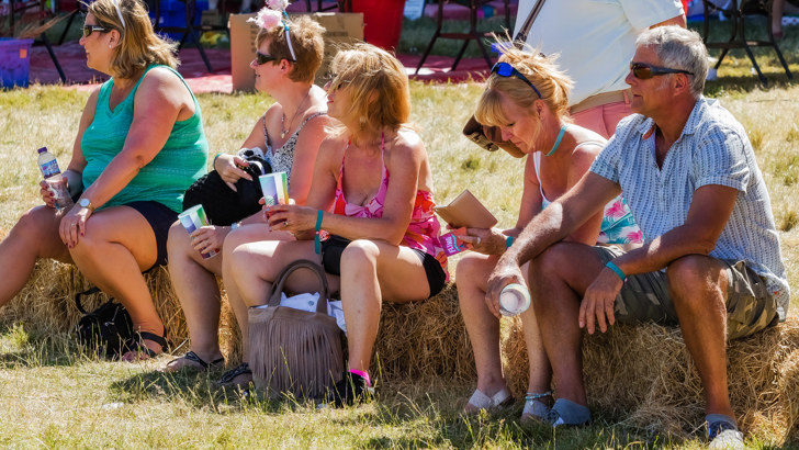 Fling attendees hanging out on hay bales