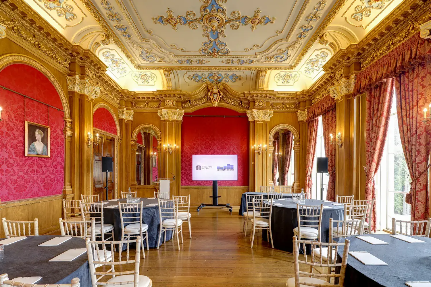 Highly decorated room, with red damask walls and gold gilding