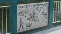 Intricate panel in bridge depicting tree and dog walker preview