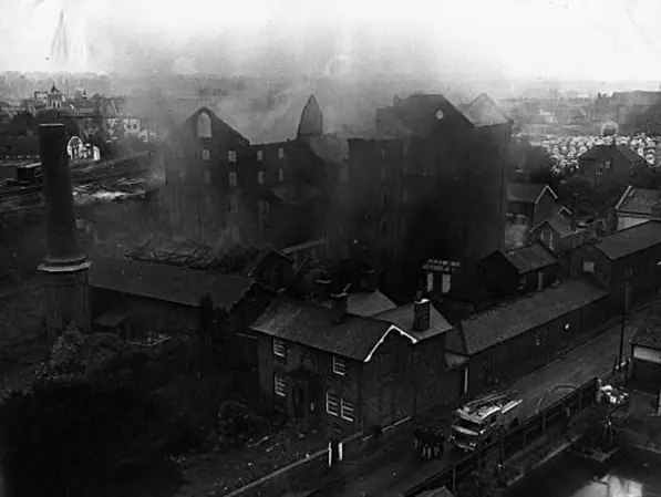 Burnt out building with smoke sill rising from it