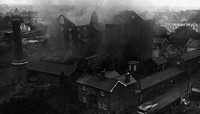 Burnt out building with smoke sill rising from it preview