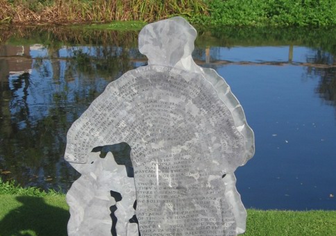 Sculpture of a man in front of river