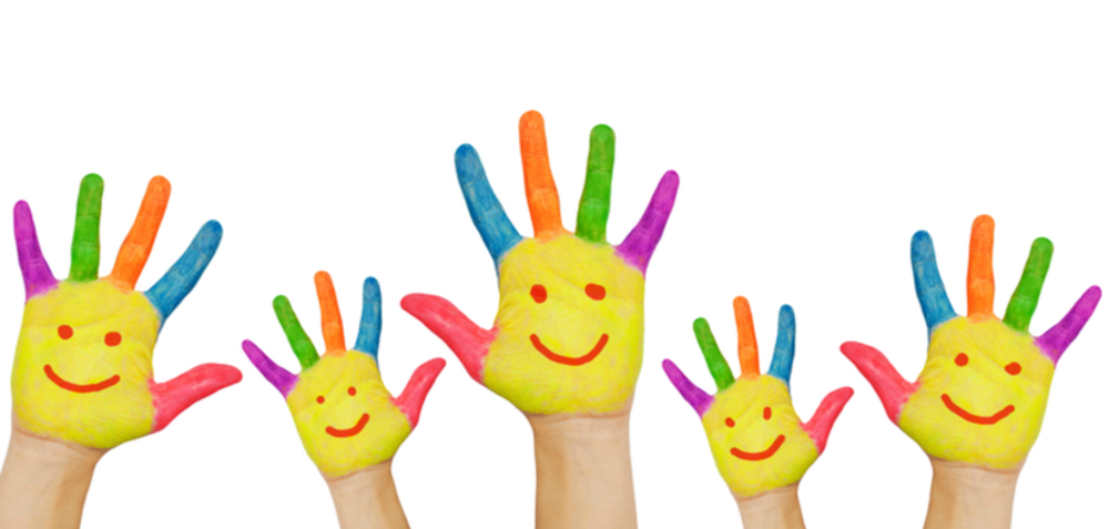 Children's hands, painted with bright colours and smiley faces