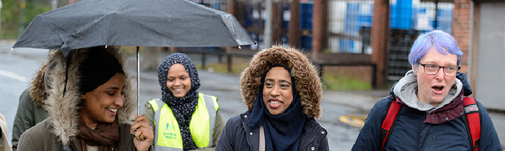 Group of smiling women on a walk in a suburban area