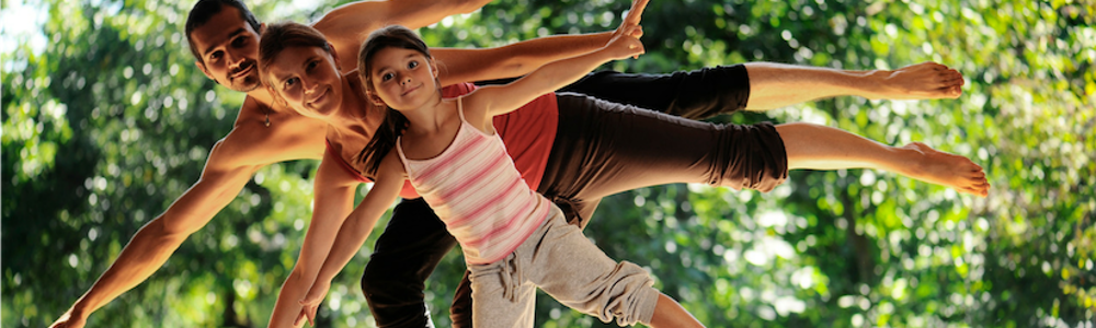 Man, woman and child all balancing on one leg