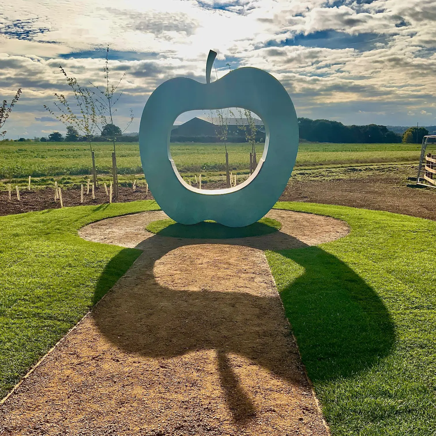 Large art installation in the shape of an apple, with hole in the middle for seating (photo credit: Julie Edwards)