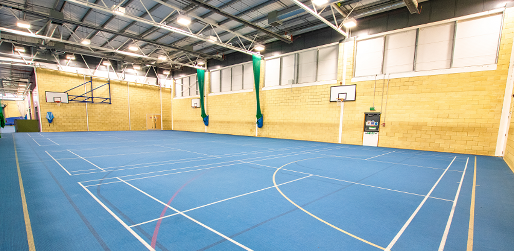 Sports hall with blue flooring and markings for different kinds of sport