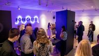 A group of people standing inside the temporary Forecast22 exhibition on its launch night.  preview