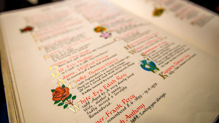 Page from Book of Remembrance, featuring hand written memorials