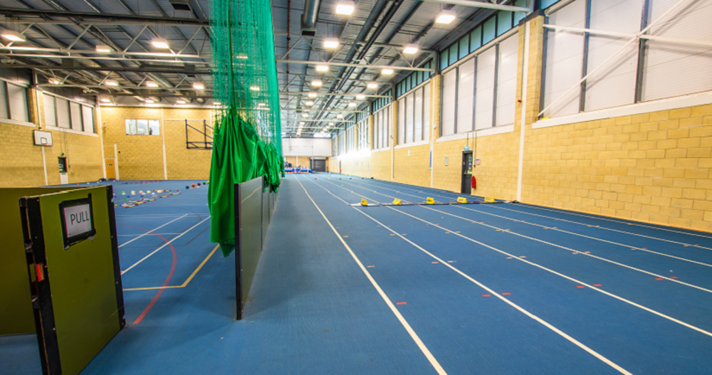 Inddor athletics track with blue flooring