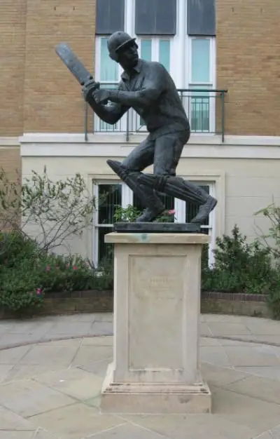 Statue of cricketer Graham Gooch on a plinth outside a house