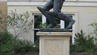 Statue of cricketer Graham Gooch on a plinth outside a house preview