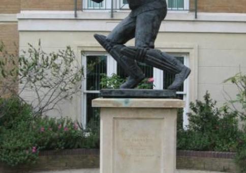Statue of cricketer Graham Gooch on a plinth outside a house