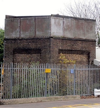 Brick tower with metal top behind metal railings (Photograph courtesy and copyright © Stuart Axe)
