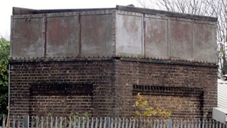 Brick tower with metal top behind metal railings (Photograph courtesy and copyright © Stuart Axe)