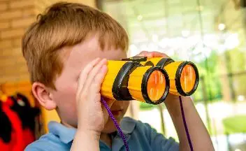 Boy using binoculars