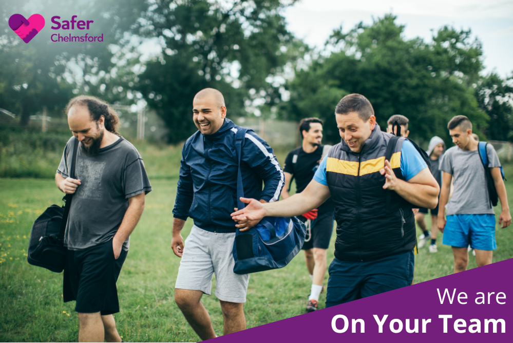 We are On Your Team (group of men walking on to field with kit bags)