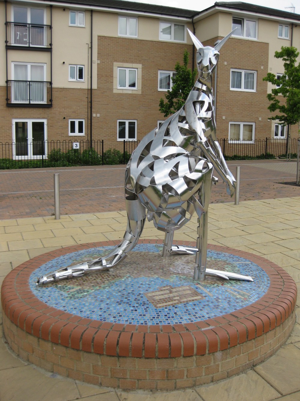 Sculpture of a kangaroo on a plinth opposite some houses