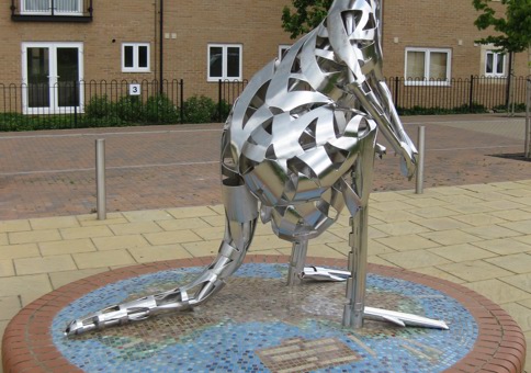 Sculpture of a kangaroo on a plinth opposite some houses
