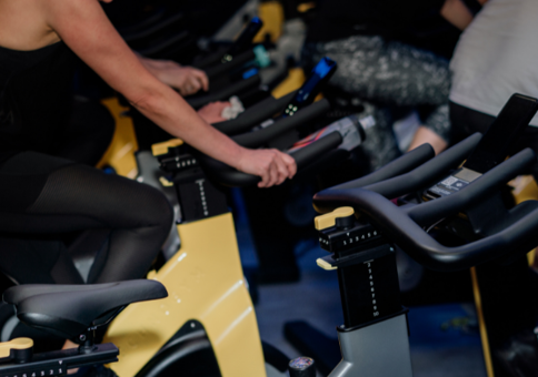 People on stationary bikes in spin studio