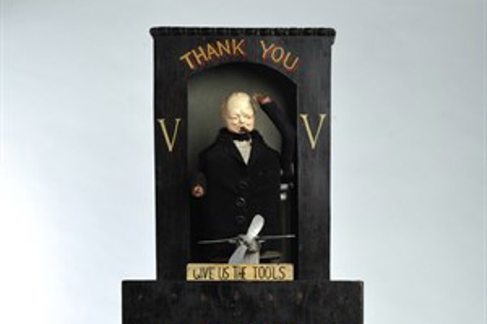 Black collection box for Chelmsford Spitfire Fund, featuring small model of Winston Churchill