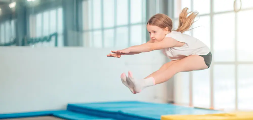 Young girl in mid air while jumping on a trampoline