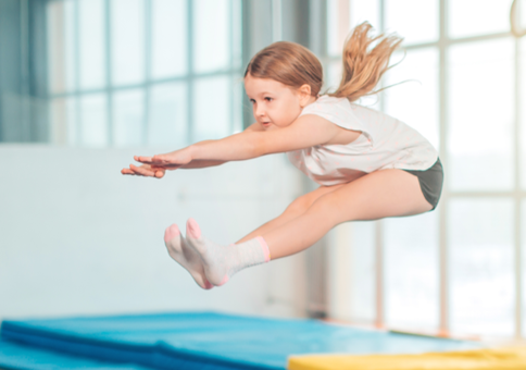Young girl in mid air while jumping on a trampoline
