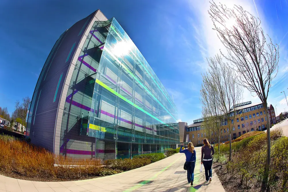 Top of a tall building with glass down the side