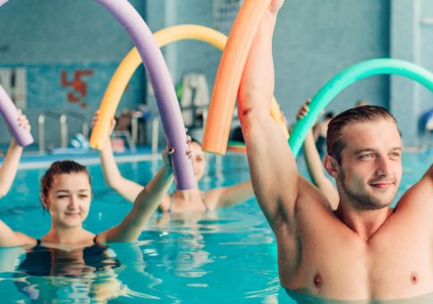 People in a swimming pool doing aqua aerobics