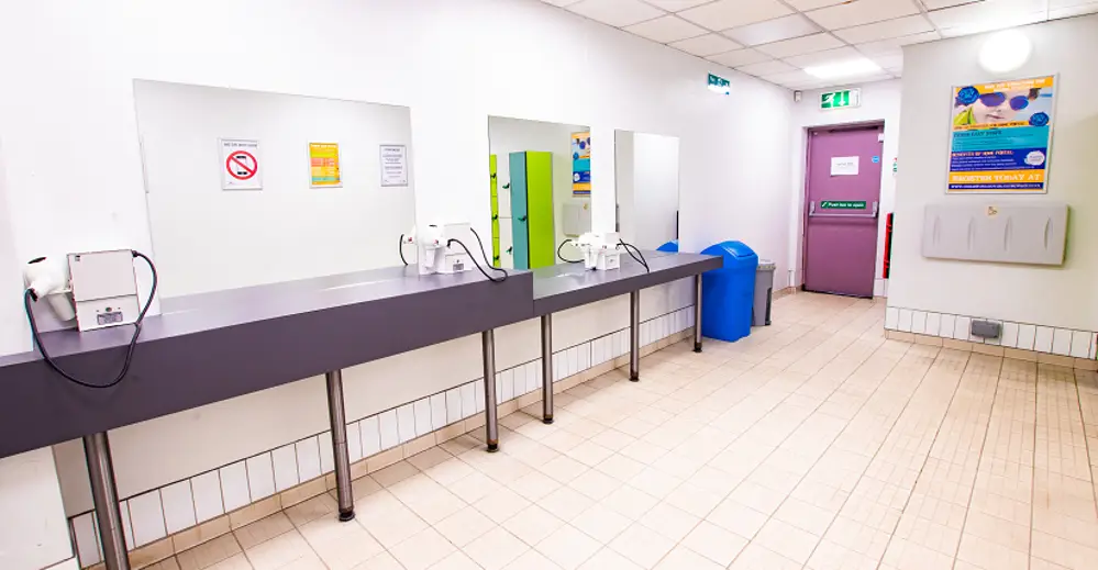 Changing rooms with open area with long counter in front of mirrors