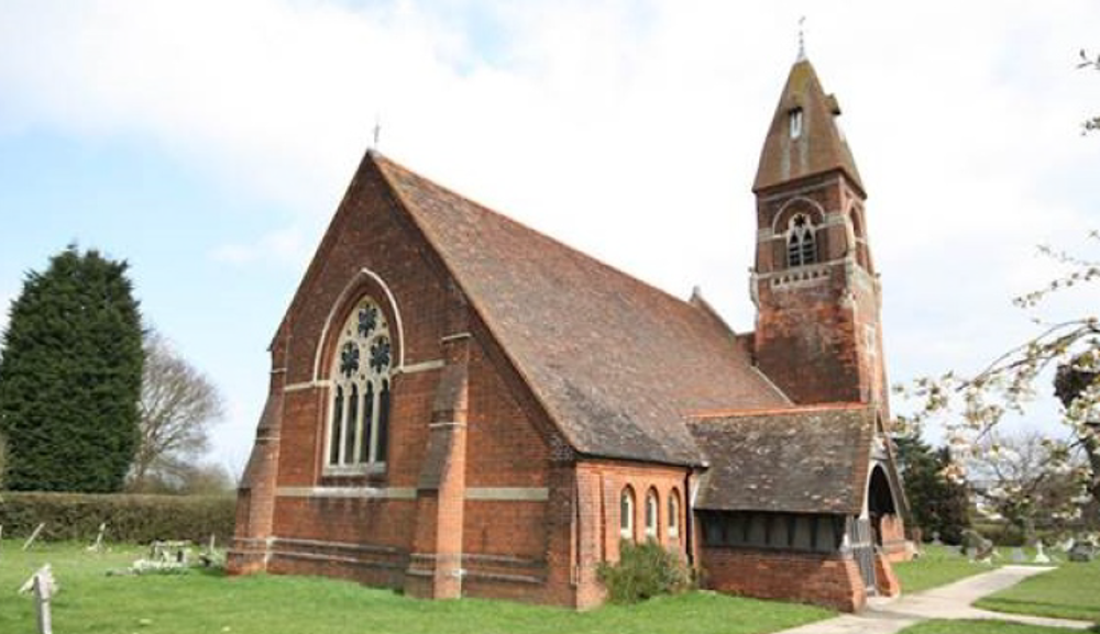Red brick church with bell tower and large porch
