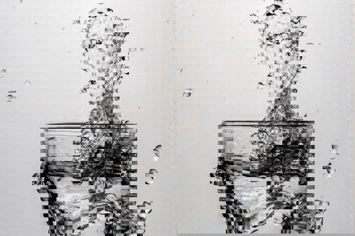 Glass of water splashing