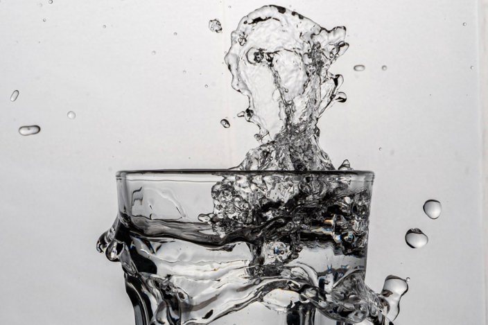 Glass of water splashing