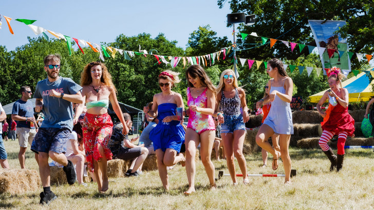 Group of friends walking around festival site