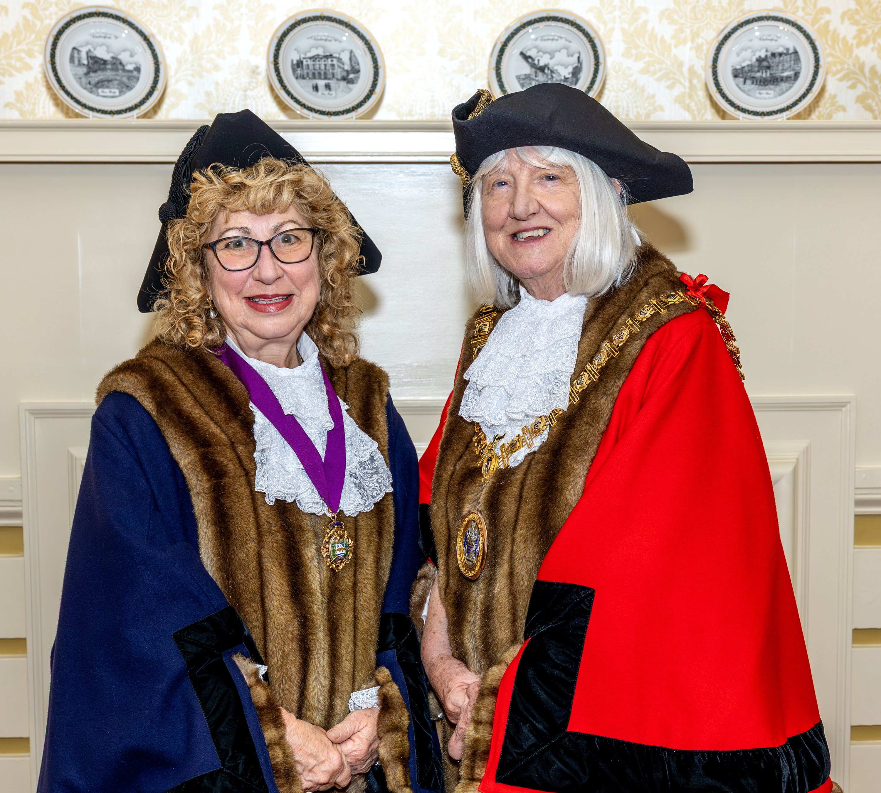 Deputy Mayor Julia Frascona wearing blue robes and Mayor Lynn Fister wearing red robes and Mayoral chain of office