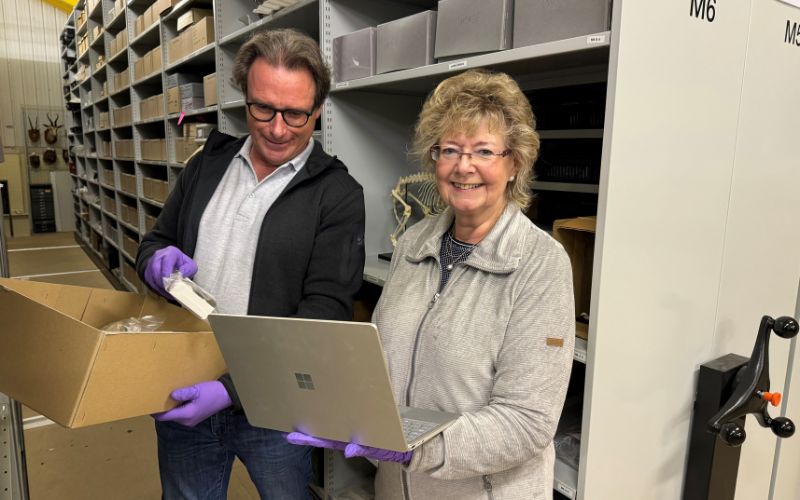 Volunteers working on their laptop while in the museum store.